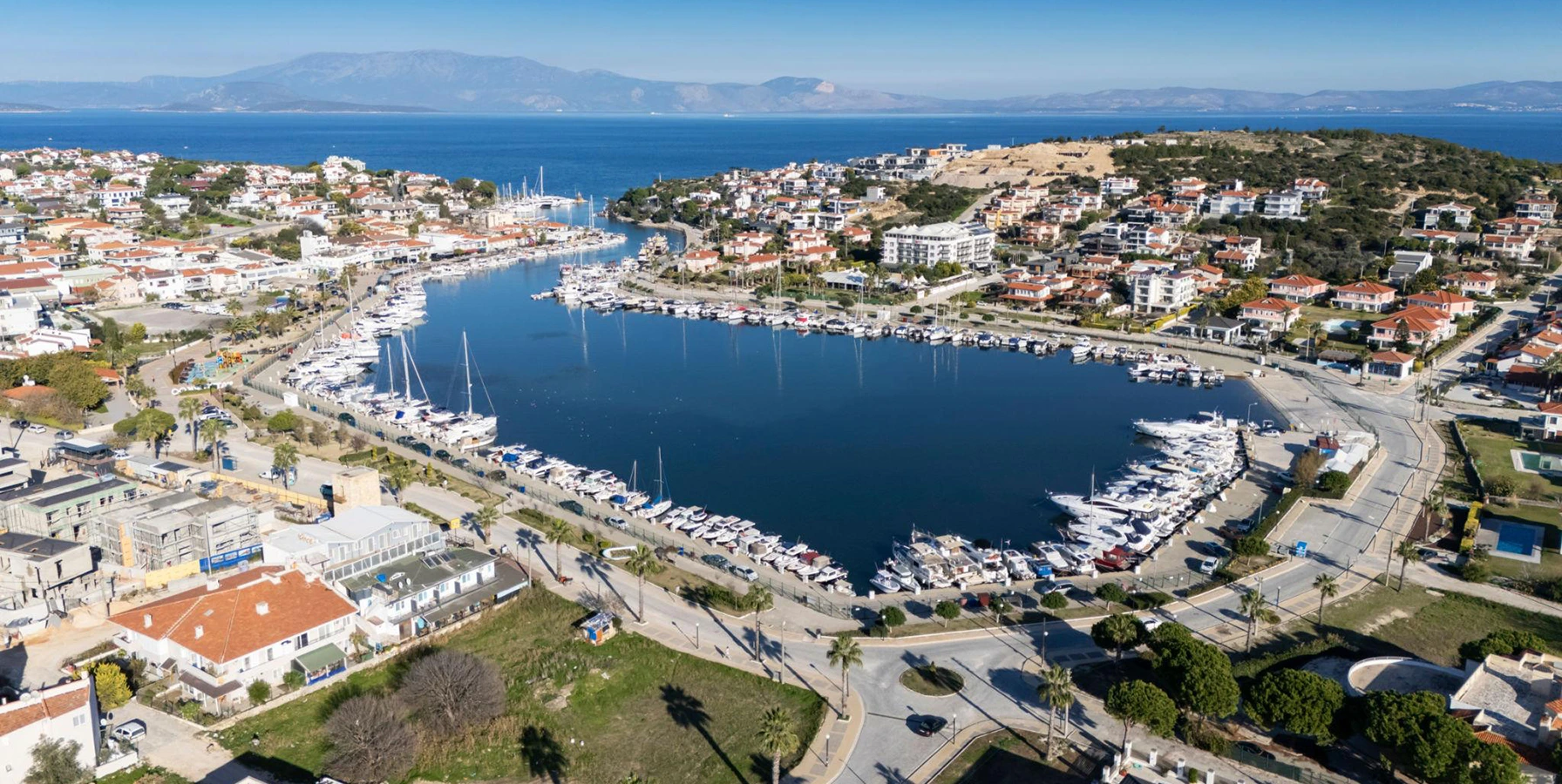 Dalyan fishing harbour boats and Aegean coastline in Cesme Izmir Turkey