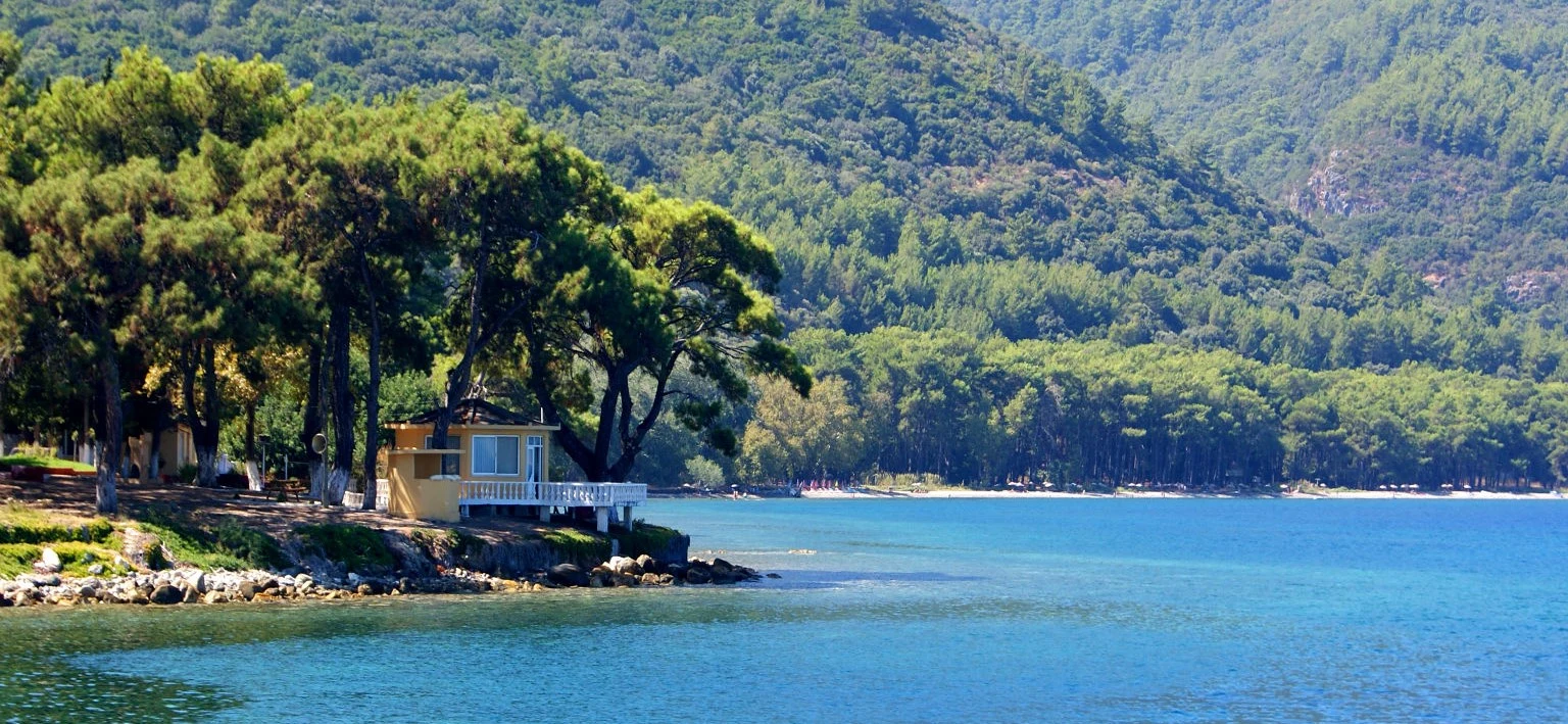 Güzelçamlı Kuşadası Aegean coastline turquoise sea and forested Dilek Mountains